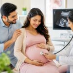 Pregnant woman attending a prenatal checkup with a gynecologist during pregnancy to monitor maternal and fetal health.